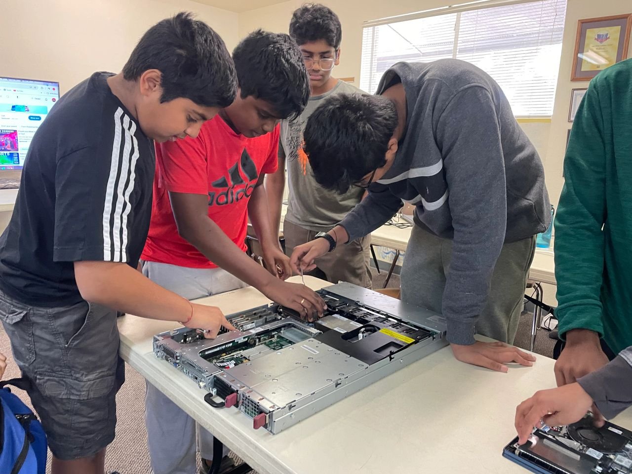 Students exploring the inside of a desktop computer